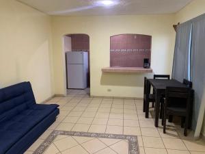a living room with a blue couch and a table at Private apartment La Paz baja in La Paz