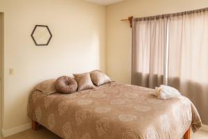 a bedroom with a bed with two pillows on it at Private apartment La Paz baja in La Paz