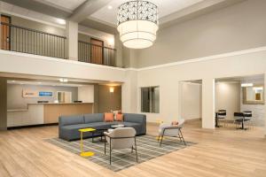 a living room with a blue couch and chairs at City Express by Marriott Danville in Danville
