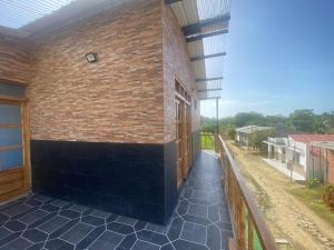 a building with a brick wall and a patio at El Castillo in Moñitos +5 photos