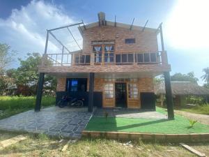 a house with a balcony on top of it at El Castillo in Moñitos