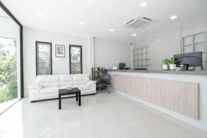 a living room with a white couch and a bar at Rayong Valley Resort in Ban Khao Chak Khaek (1)