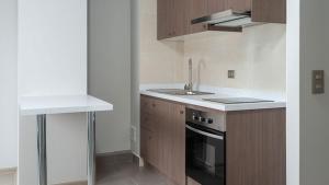 a kitchen with a sink and a stove at Departamento en Villarrica con Piscina y Estacionamiento Privado in Villarrica