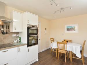 a kitchen and dining room with a table at Westburn in Comrie
