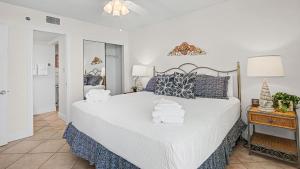 a bedroom with a large bed with towels on it at Beachcrest 805 in Santa Rosa Beach +52 photos