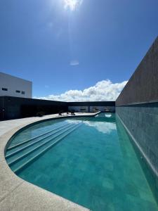 a swimming pool on the roof of a building at Flat beira mar Olinda Jam in Olinda