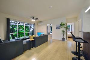 a large living room with a couch and chairs at 064Villa 美海璃 in Nanjo