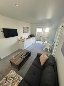 a living room with a couch and a table at Sea Escape in Whitianga