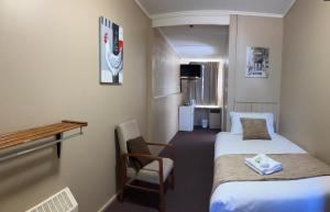 a room with two beds and a table and a chair at Berridale Inn in Berridale