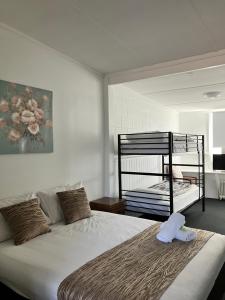 a bedroom with a bed with a towel on it at Berridale Inn in Berridale