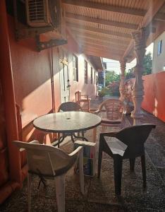 a patio with tables and chairs and a table and chairs at Runnyaway Inn in Bon Accord