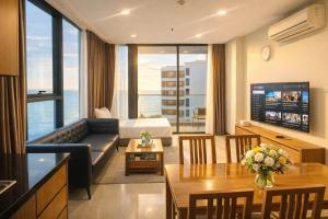 a living room with a couch and a table at Holi Beach Hotel & Apartments in Nha Trang