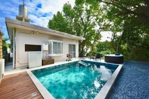a swimming pool in the backyard of a house at 064Villa 美海璃 in Nanjo