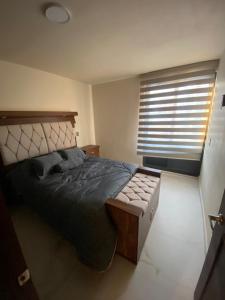 a bedroom with a large bed and a window at Casa Mexiquito in Arandas +12 photos