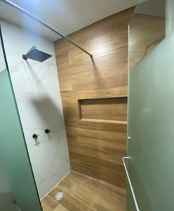 a bathroom with a shower with a wooden wall at Casa Mexiquito in Arandas