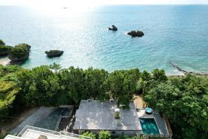an aerial view of a house in the water at 064Villa 美海璃 in Nanjo