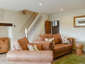 a living room with a couch and a chair at Rooftops - Uk34065 in Grassington