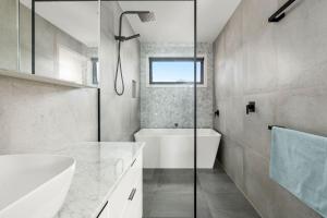 a bathroom with a tub and a sink and a shower at Coastal Ember in Inverloch +16 photos
