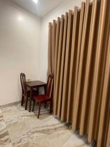 a dining room with a table and a wooden fence at Khách sạn Kiến Đức in Kiến Ðức