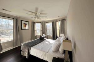 a bedroom with a bed with a ceiling fan at 25 Lux Room 3 - 1 Queen Bed, Shared Bathroom - Nonsmoking in Arlington