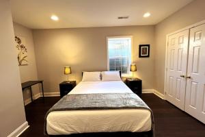 a bedroom with a bed with two night stands and a window at 25 Lux Room 6 - 1 Queen Bed, Shared Bathroom - Nonsmoking in Arlington