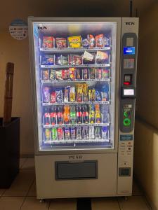 a vending machine filled with drinks and soda at Habitaciones con C in Concepción
