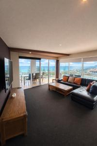 a living room with a couch and a table at Ocean View-breath Taking Views, Amazing Facilities in Perth