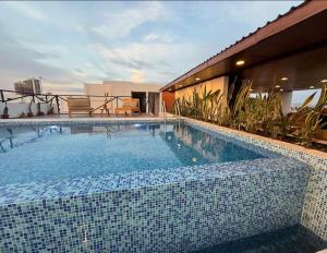a large swimming pool sitting on top of a building at Departamento San Lorenzo #102 in Mazatlán