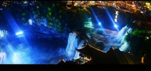 a view of a waterfall at night with lights at Tu Wang Ju Ke Zhan in Yongshun