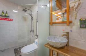 a bathroom with a sink and a toilet at Tu Wang Ju Ke Zhan in Yongshun +34 photos