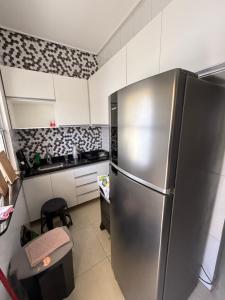 a kitchen with a stainless steel refrigerator at CASA DE PRAIA EM PRAIA BELA PITIMBu PB in Pitimbu