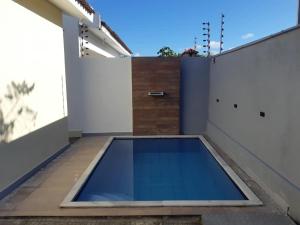 a swimming pool on the roof of a house at CASA DE PRAIA EM PRAIA BELA PITIMBu PB in Pitimbu