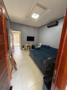 a bedroom with a bed and a living room at CASA DE PRAIA EM PRAIA BELA PITIMBu PB in Pitimbu