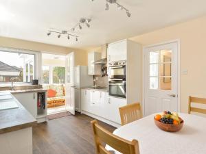 a kitchen with a table with a bowl of fruit on it at Westburn in Comrie