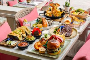 a table topped with plates of food and bowls of food at Waldorf Towers South Beach in Miami Beach +48 photos