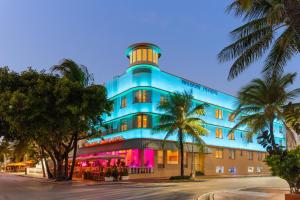 a blue building with a clock tower on top of it at Waldorf Towers South Beach in Miami Beach