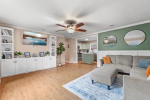 a living room with a couch and a ceiling fan at Summerville’s Tea House in Summerville