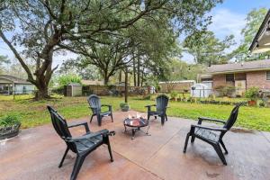 a group of chairs and a fire pit on a patio at Summerville’s Tea House in Summerville