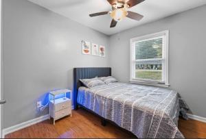 a bedroom with a bed and a ceiling fan at Summerville’s Tea House in Summerville