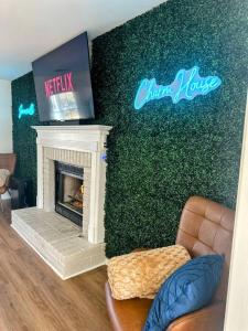 a living room with a fireplace and a green wall at Summerville’s Charm House in Summerville