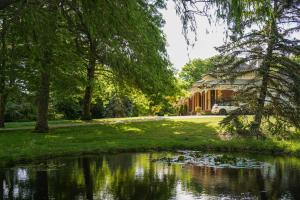 a house with a pond in front of a house at St Agnes by Prunella in Kyneton