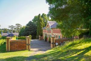 a house with a brick fence in front of it at St Agnes by Prunella in Kyneton
