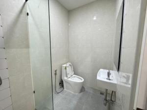 a bathroom with a shower and a toilet and a sink at Villa nabon in Ban Suan