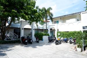 a group of motorcycles parked in front of a building at Villa nabon in Ban Suan