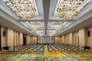 a large room with rows of chairs and chandeliers at Myze Hotel Waingapu in Waingapu +39 photos