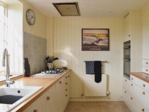 a kitchen with a sink and a counter top at Coachmans Close in Milverton