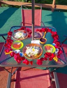 a table with plates of food and flowers on it at Cabañas El Amanecer in Cuetzalán del Progreso