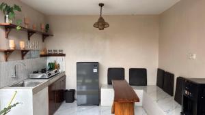 a kitchen with a sink and a wooden table at Villa Bumi Detani in Selabintana