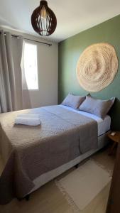 a bedroom with a large bed with a basket on the wall at Ap Mirante Fortaleza 5min da Praia com Piscina e Rooftop para 6 pessoas in Fortaleza +36 photos