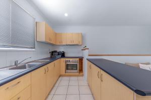 a kitchen with a sink and a counter top at PET FRIENDLY Coolview in Cannonvale +9 photos